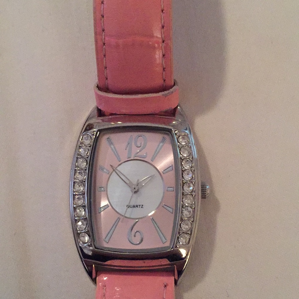 Avon pink strapped watch with mother of pearl pink face